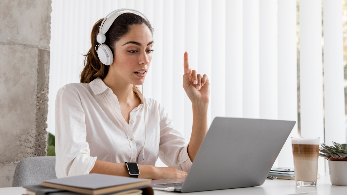 Woman wearing headphones working on a laptop during a virtual assistant session.  Select 88 more words to run Humanizer.