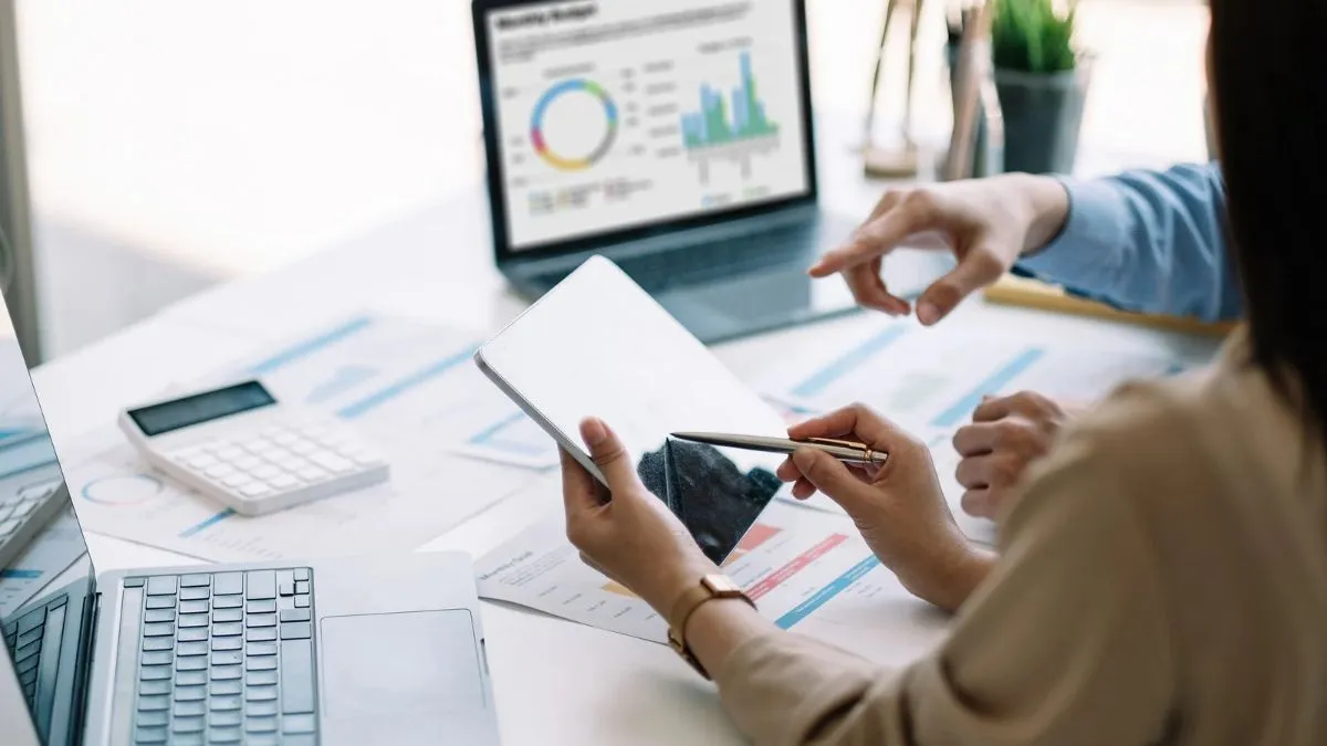 Business intelligence analysis with financial reports, data charts, and a team reviewing business performance